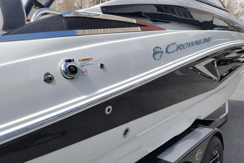 Slide: The Image of 2026 Crownline Eclipse E255 boat exterior with sleek design and branding. - 29