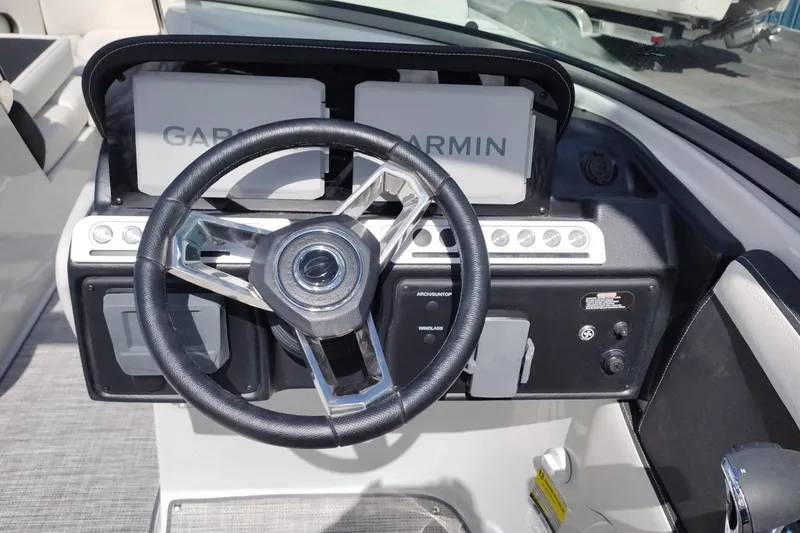 Slide: The Image of Steering wheel and dashboard of 2026 Crownline Eclipse E255 boat with Garmin navigation. - 34