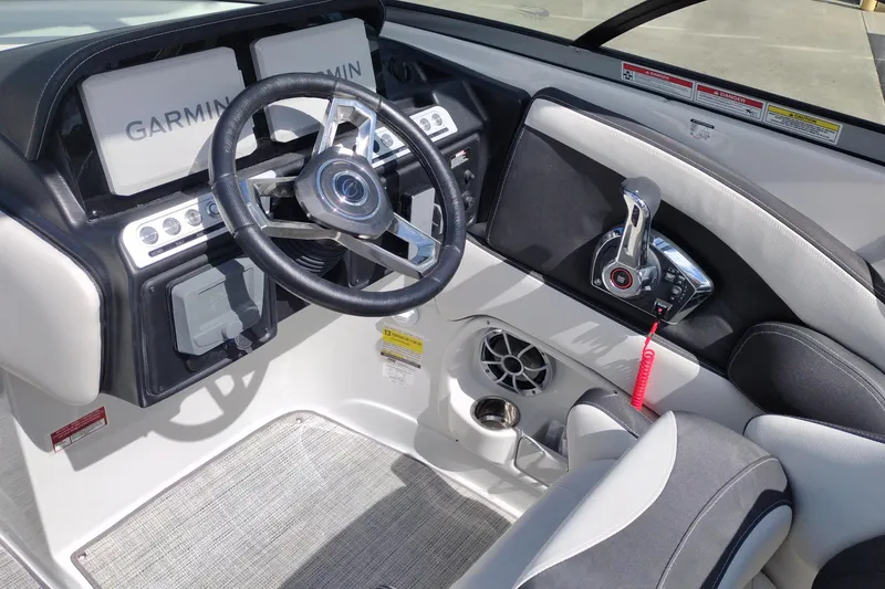 Slide: The Image of 2026 Crownline Eclipse E255 boat cockpit with Garmin navigation and modern controls. - 35