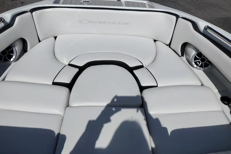 Slide: The Image of 2026 Crownline Eclipse E255 boat interior with white cushioned seating and speaker system. - 36