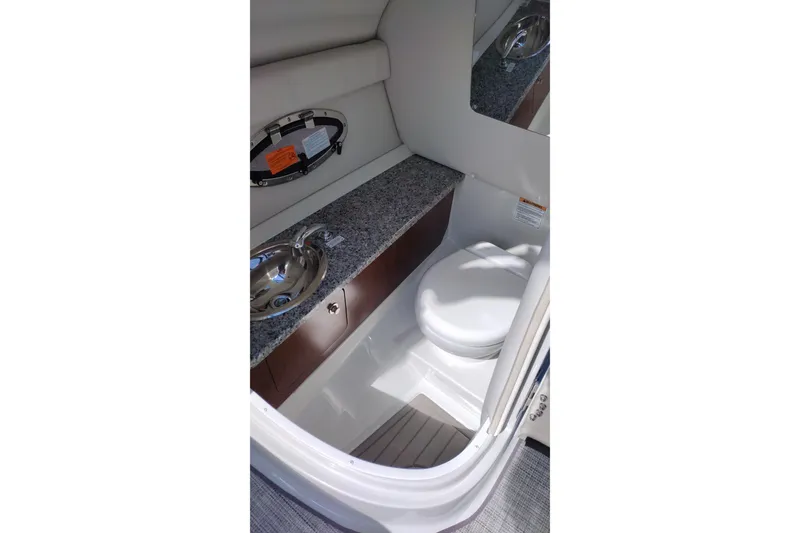 Slide: The Image of 2026 Crownline Eclipse E255 boat interior with sink and toilet. - 38