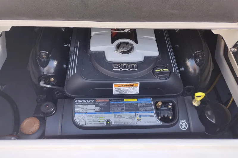 Slide: The Image of Engine compartment of a 2026 Crownline Eclipse E255 boat, featuring a Mercury 300 engine. - 44
