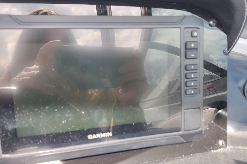 Slide: The Image of Garmin display on 2026 Crownline Eclipse E255 boat dashboard, reflecting surroundings. - 53