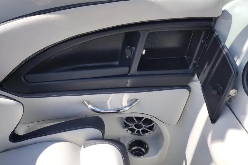 Slide: The Image of Interior of 2026 Crownline Eclipse E255 boat, featuring storage compartment and speaker. - 54