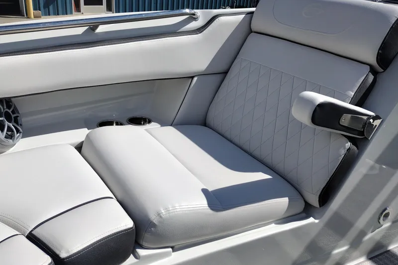 Slide: The Image of 2026 Crownline Eclipse E255 boat interior with luxurious white seating and cup holders. - 57