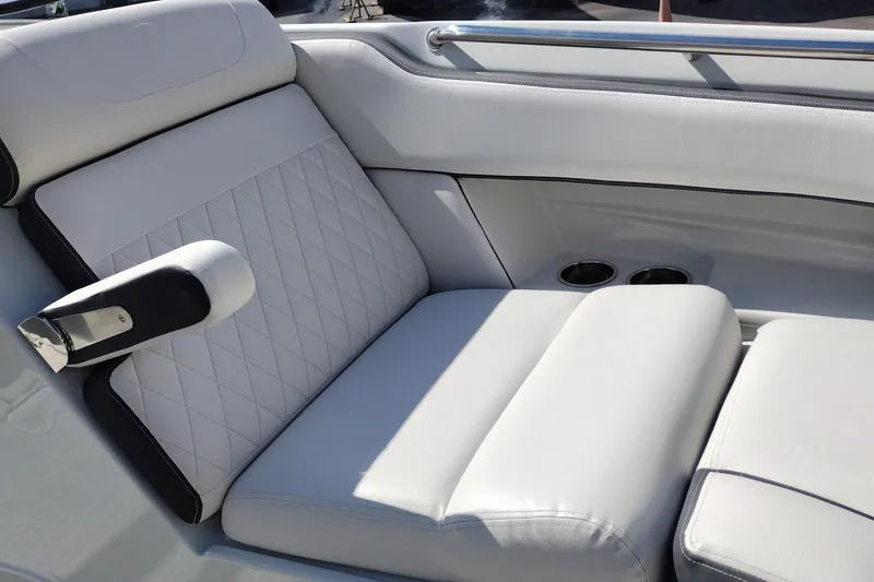 Slide: The Image of Luxurious seating on 2026 Crownline Eclipse E255 boat with cup holders and armrest. - 58