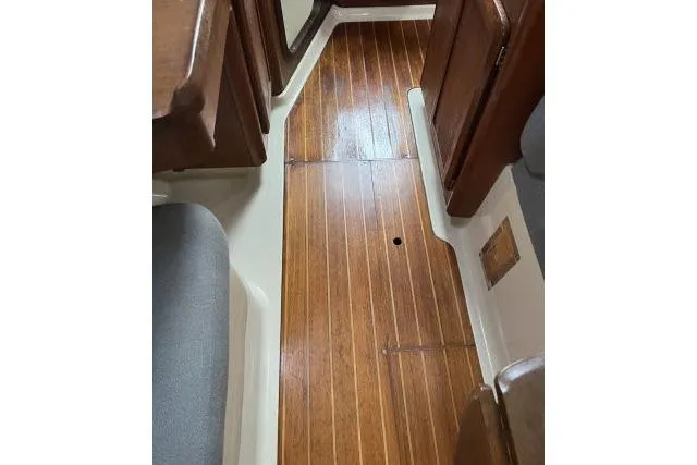 Slide: The Image of 1995 Hunter 336 interior with wooden flooring and cabin seating. - 10