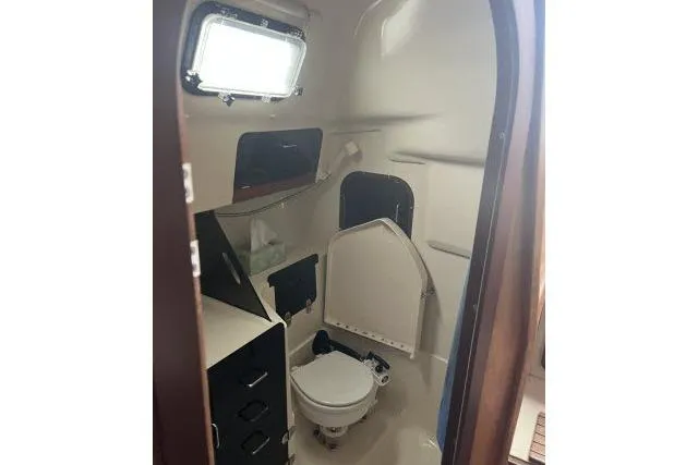 Slide: The Image of 1995 Hunter 336 sailboat bathroom interior with toilet and storage cabinets. - 13