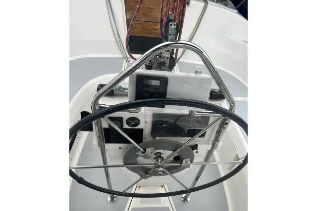 Slide: The Image of 1995 Hunter 336 sailboat helm with steering wheel and navigation instruments. - 16