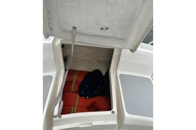 Slide: The Image of Open storage compartment on 1995 Hunter 336 sailboat with life jackets inside. - 18