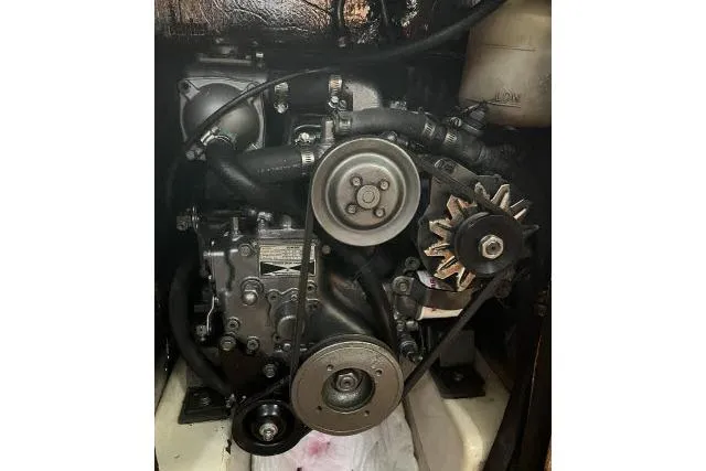 Slide: The Image of 1995 Hunter 336 engine with visible belts and components. - 21