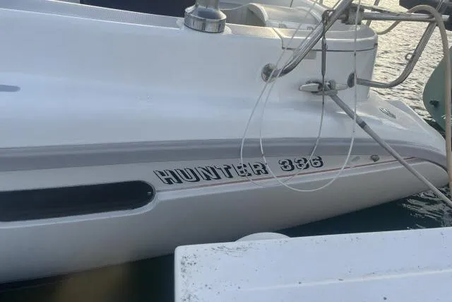 Slide: The Image of 1995 Hunter 336 yacht kitchen with stove, sink, and seating area. - 5