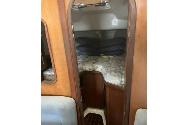 Slide: The Image of Interior cabin of 1995 Hunter 336 sailboat with wooden finish and bedding. - 8