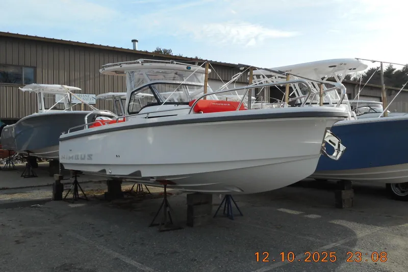 The Image of 2025 Nimbus Tender 8 boat displayed on stands outside a warehouse. - 0