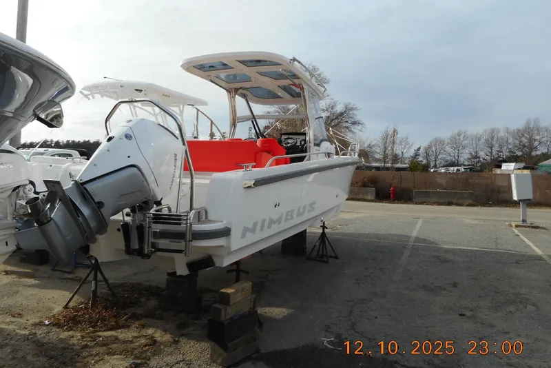 Slide: The Image of 2025 Nimbus Tender 8 boat with outboard motor in a parking lot. - 14