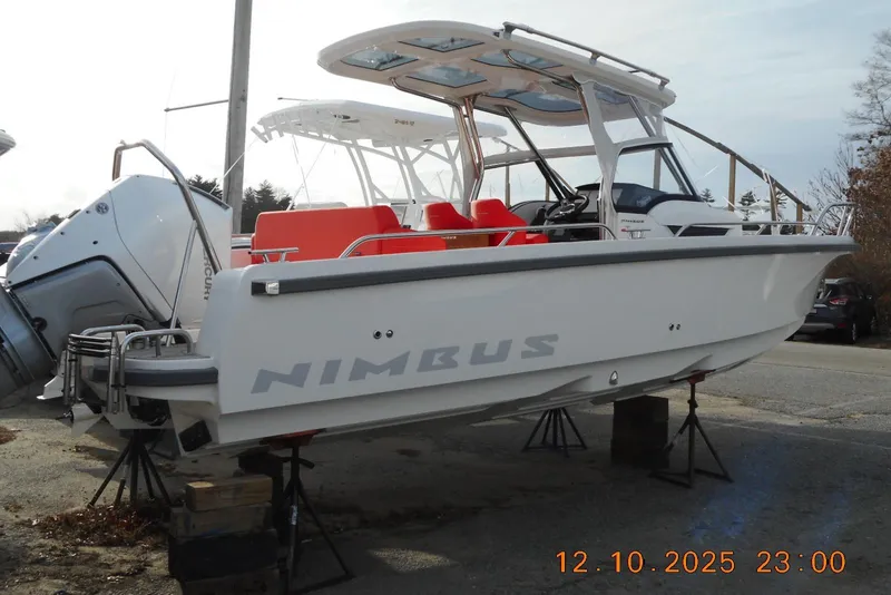 Slide: The Image of 2025 Nimbus Tender 8 boat on stands, featuring red seating and Mercury outboard engine. - 15