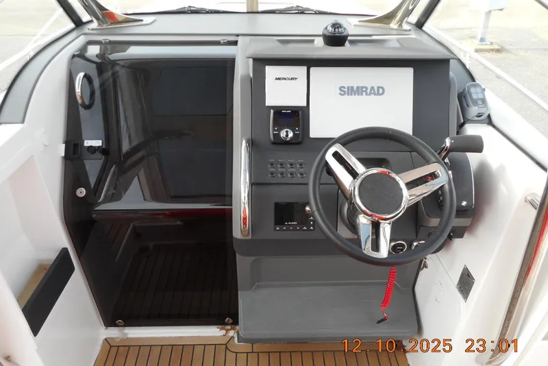 Slide: The Image of 2025 Nimbus Tender 8 boat cockpit with steering wheel and navigation controls. - 17