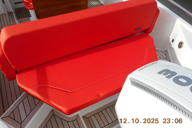 Slide: The Image of Red seating on 2025 Nimbus Tender 8 boat with Mercury engine. - 23