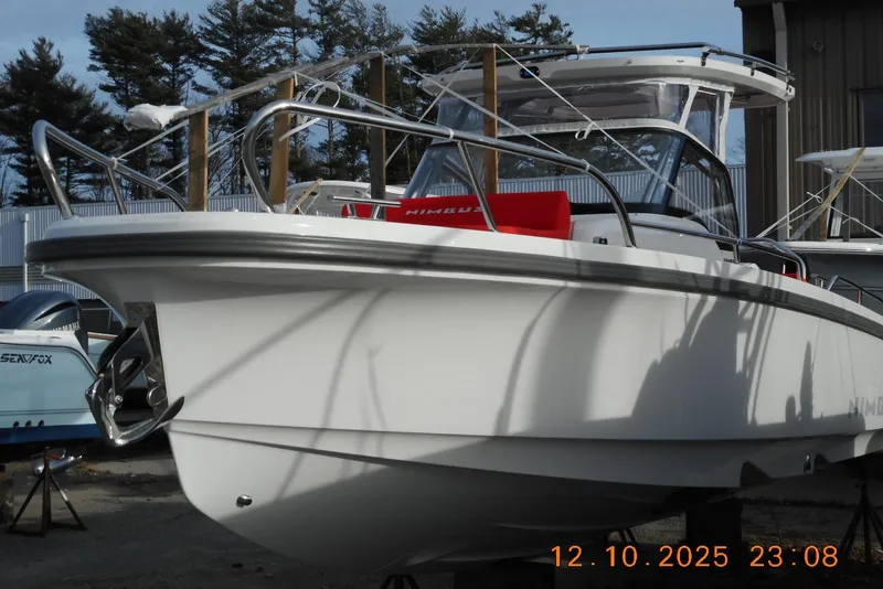 Slide: The Image of 2025 Nimbus Tender 8 boat with sleek design, docked outdoors. - 5