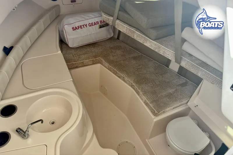 Slide: The Image of 2008 Grady-White Gulfstream 232 cabin interior with sink, seating, and safety gear bag. - 11