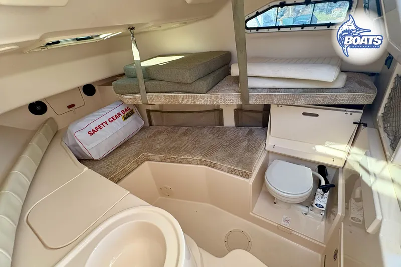 Slide: The Image of 2008 Grady-White Gulfstream 232 cabin interior with safety gear bag and compact toilet. - 12