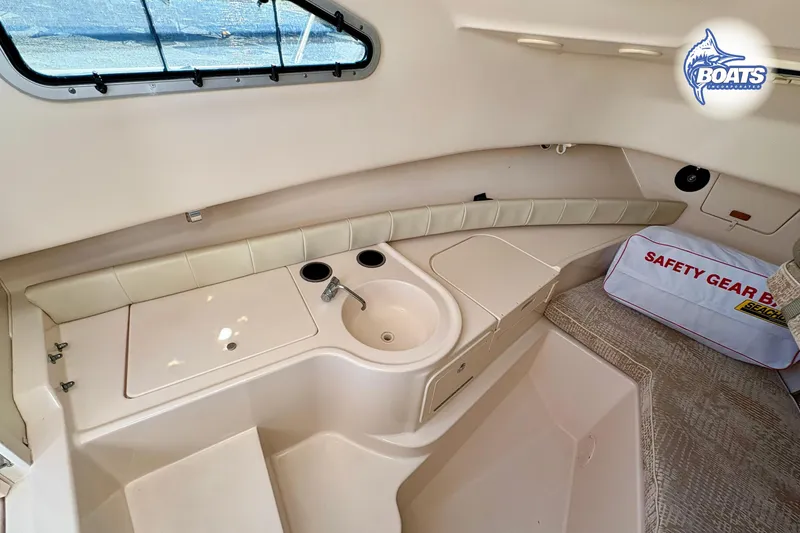 Slide: The Image of 2008 Grady-White Gulfstream 232 cabin interior with sink and safety gear bag. - 13