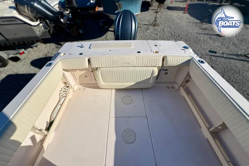 Slide: The Image of 2008 Grady-White Gulfstream 232 boat interior with cushioned seating and storage compartments. - 15