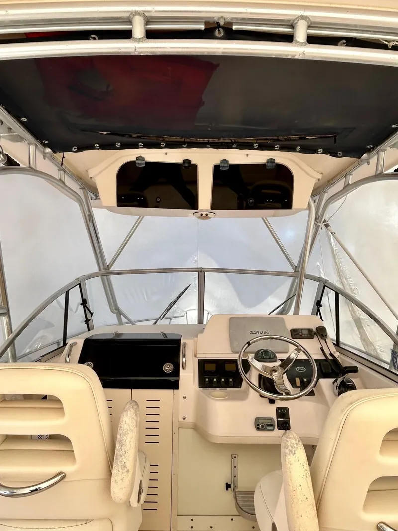 Slide: The Image of 2008 Grady-White 232 Gulfstream WA boat interior with steering wheel and controls. - 18