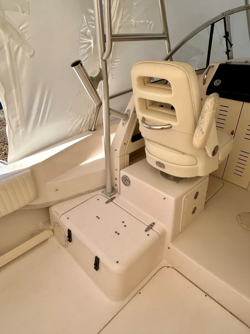 Slide: The Image of 2008 Grady-White 232 Gulfstream WA boat interior with captain's chair and helm. - 21