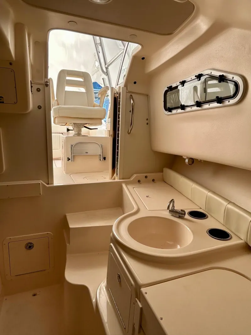 Slide: The Image of 2008 Grady-White 232 Gulfstream WA cabin interior with sink and seating. - 23