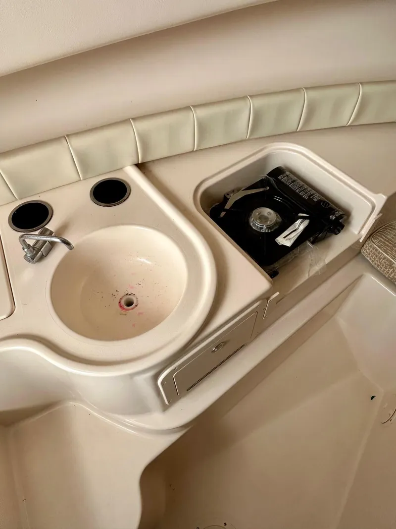 Slide: The Image of 2008 Grady-White 232 Gulfstream WA boat interior with sink and stove. - 25