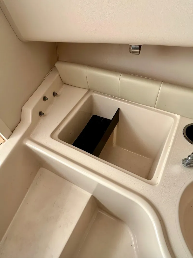 Slide: The Image of Interior of 2008 Grady-White 232 Gulfstream WA boat, featuring a compact sink area. - 26