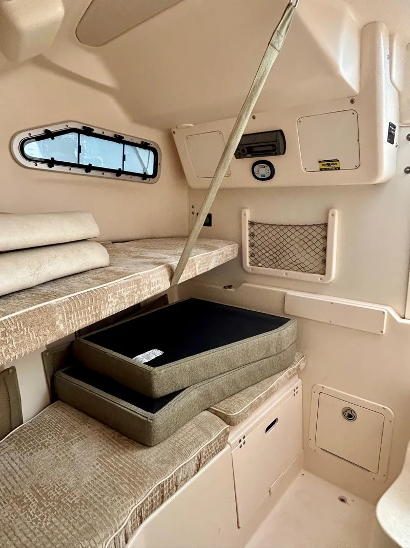 Slide: The Image of Interior cabin of 2008 Grady-White 232 Gulfstream WA boat with cushions and storage. - 27