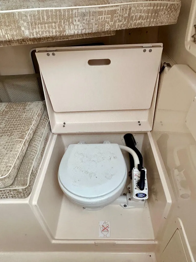 Slide: The Image of 2008 Grady-White 232 Gulfstream WA boat interior with compact marine toilet. - 28