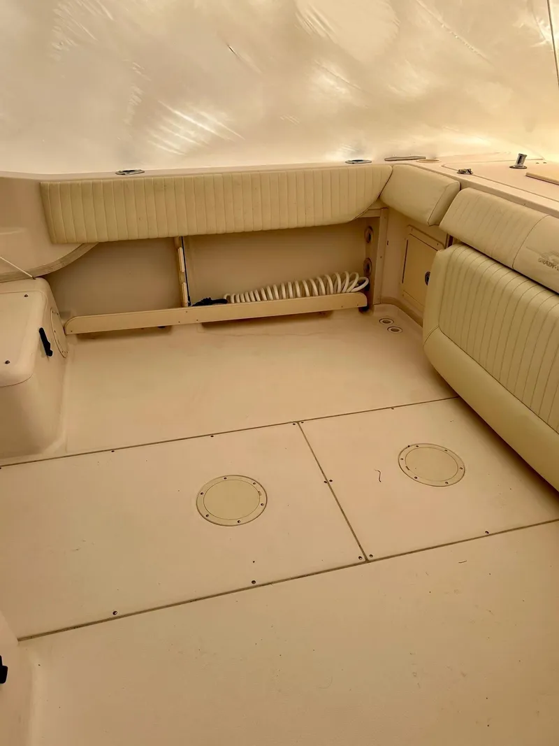 Slide: The Image of 2008 Grady-White 232 Gulfstream WA boat interior with beige seating and storage compartments. - 30