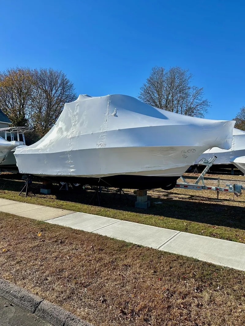 Slide: The Image of 2008 Grady-White 232 Gulfstream WA boat covered, parked outdoors. - 33