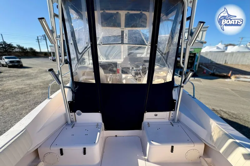 Slide: The Image of 2008 Grady-White Gulfstream 232 boat cockpit with clear enclosure and steering wheel. - 5