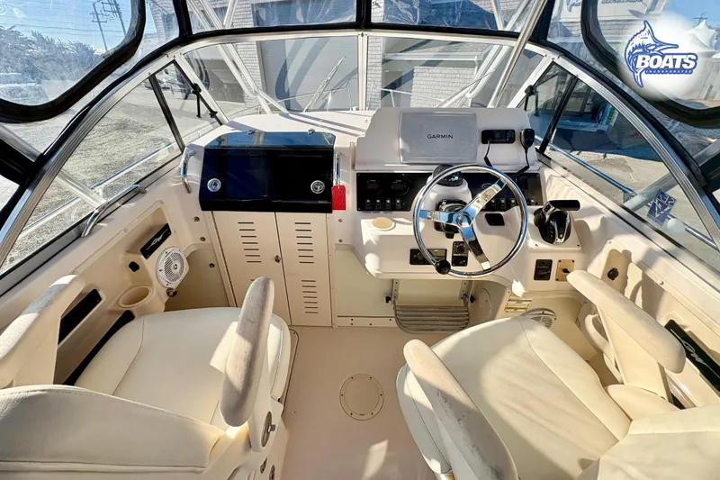 Slide: The Image of 2008 Grady-White Gulfstream 232 boat cockpit with steering wheel and navigation equipment. - 6