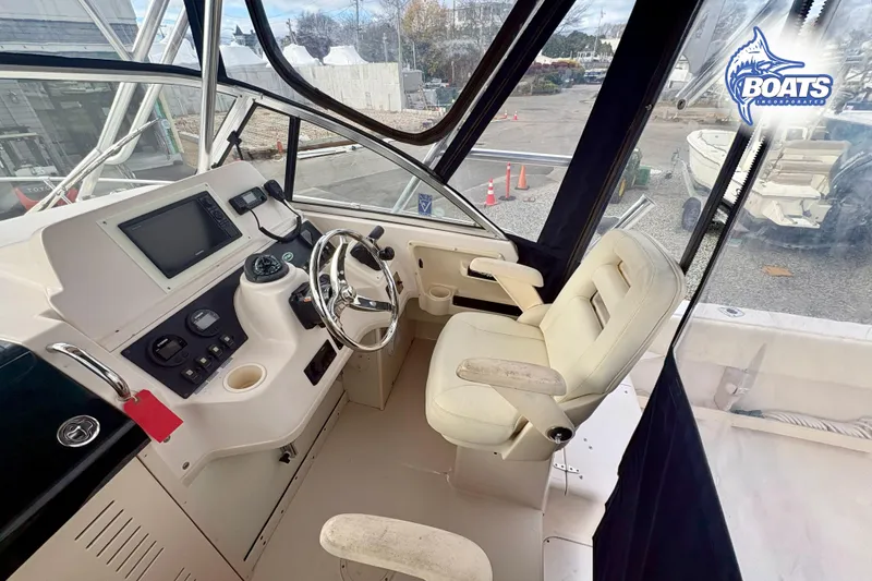 Slide: The Image of 2008 Grady-White Gulfstream 232 boat cockpit with steering wheel and control panel. - 7