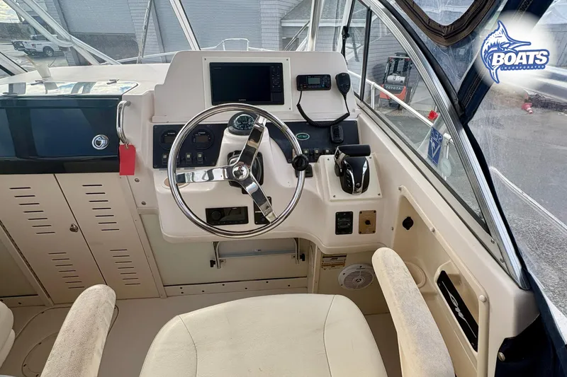 Slide: The Image of 2008 Grady-White Gulfstream 232 boat helm with steering wheel and controls. - 8