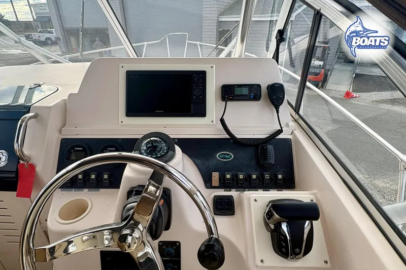 Slide: The Image of 2008 Grady-White Gulfstream 232 boat dashboard with steering wheel and navigation controls. - 9