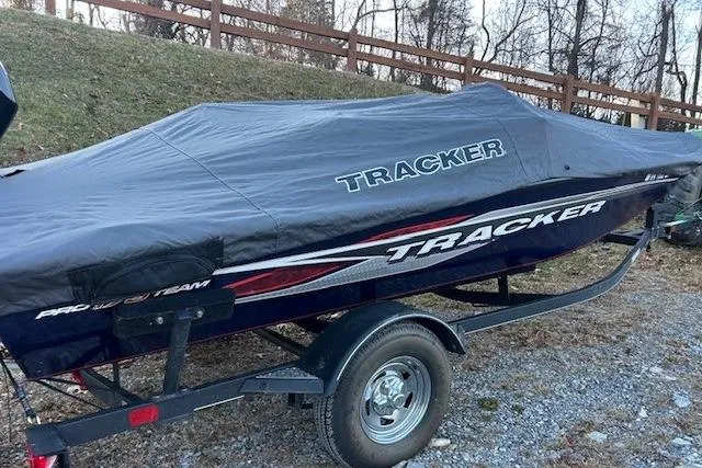 Slide: The Image of 2020 Tracker Pro Team 175 TF boat covered on trailer, parked outdoors. - 3