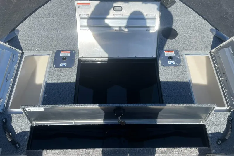Slide: The Image of Open storage compartments on a 2025 Lowe Deck SD224 boat. - 13
