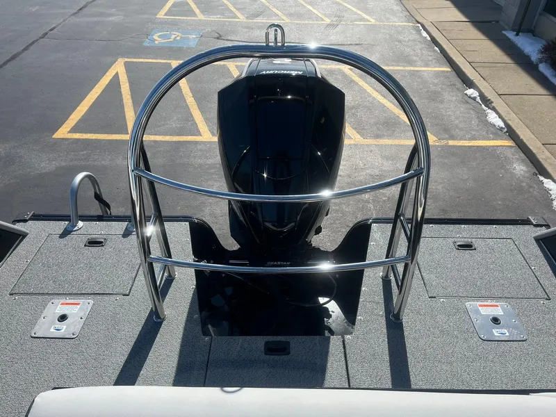 Slide: The Image of 2025 Lowe Deck SD224 boat engine with protective railing, parked on asphalt. - 17