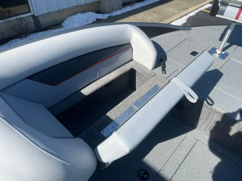 Slide: The Image of 2025 Lowe Deck SD224 boat interior with gray seating and storage compartment. - 26
