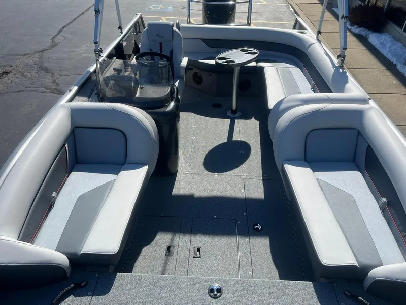 Slide: The Image of 2025 Lowe Deck SD224 boat interior with gray seating and steering console. - 8