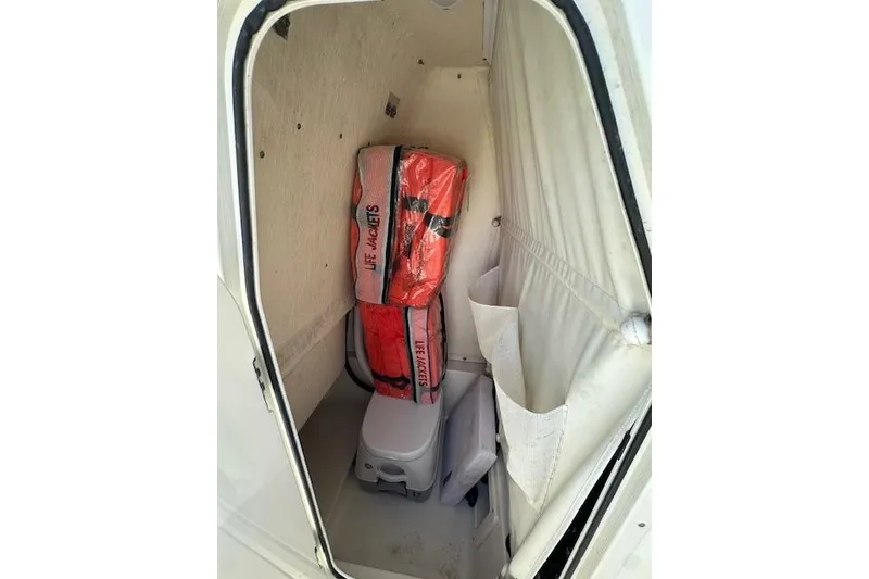 Slide: The Image of Interior of 2022 Key West 239 FS boat with life jackets and portable toilet. - 11