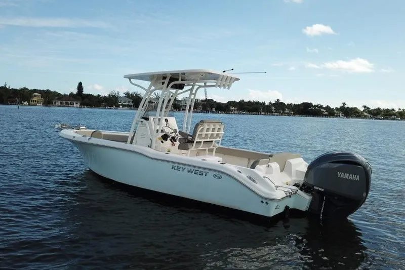 Slide: The Image of 2022 Key West 239 FS boat on calm water with Yamaha engine. - 2