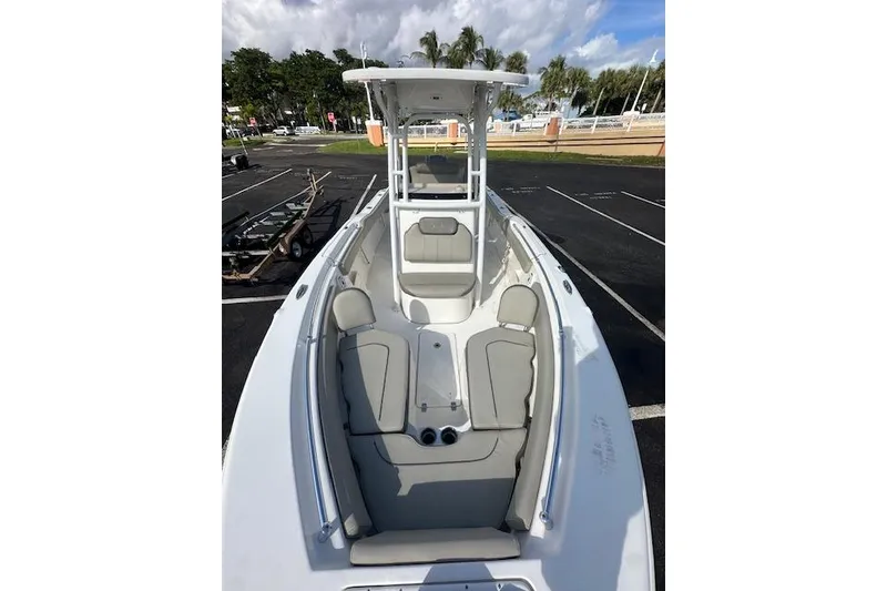Slide: The Image of 2022 Key West 239 FS boat with spacious seating and sleek design in a parking area. - 8