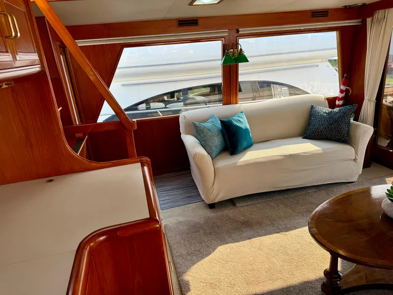 Slide: The Image of Interior of 1985 Ocean Alexander Custom Aft Deck Motoryacht with sofa and large windows. - 10